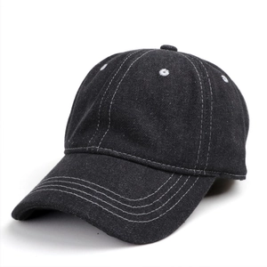 Detail of washed black denim baseball cap featuring white contrast stitching and soft crown