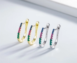 Detail of 925 sterling silver U-shaped earrings with colorful zircon in gold and silver