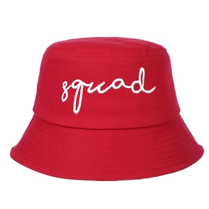 Detailed close-up of white squad embroidery on a red cotton twill bucket hat