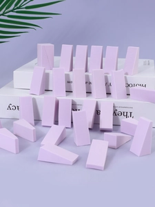 Macro shot of multiple lavender wedge-shaped makeup sponges for precise application