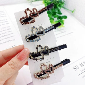 Detail view of four-piece double heart rhinestone hair clips in multiple colors
