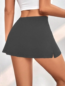 Detail view of high waisted dark grey skirt with side slit and slim fit cut from behind