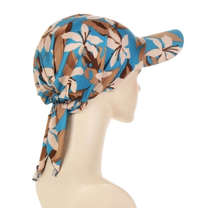 Detail of floral headscarf cap with large blue and brown botanical leaf patterns