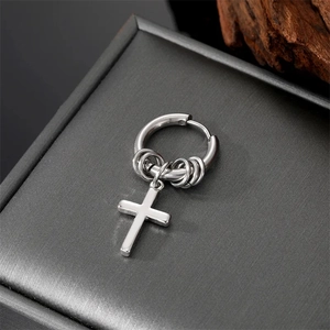 Punk silver stainless steel hoop earring with cross and rings on a jewelry box