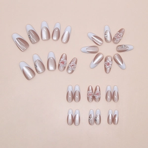 Macro detail of French cat eye press-on nails with 3D resin flowers and pearls