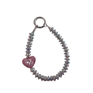 Silver phone charm with pink rhinestone circles and heart pendant on white background