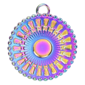 Macro shot of iridescent rainbow metal pendant with radial sunburst texture and beaded edge