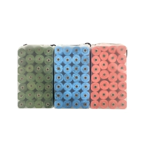 Three packs of green, blue, and orange biodegradable pet waste bags in small rolls