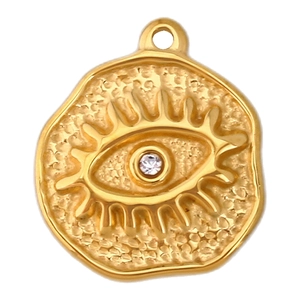 Macro shot of gold-plated evil eye charm with crystal inlay and hammered metal texture