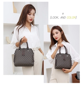 Detail view of brown printed handbag with classic monogram pattern and sturdy top handles