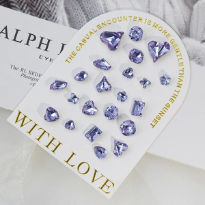 Purple K9 crystal nail art rhinestones in heart, round and drop shapes on display card