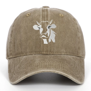 Close-up of white cow head embroidery on khaki washed cotton baseball cap with vintage finish