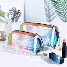 Macro shot of two holographic PVC makeup bags with iridescent rainbow gradient finish