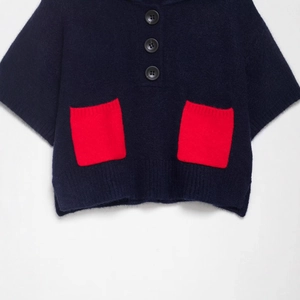 Navy blue short sleeve knit sweater featuring two red contrast pockets and button detail