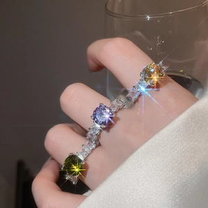 Detailed close-up of colorful round gemstone rings with pave-set baguette zircon band
