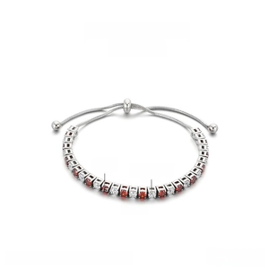 Detail view of 3mm red and white zircon tennis bracelet with adjustable drawcord closure