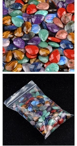 Macro detail of faceted teardrop crystal beads in mixed colors inside a transparent bag
