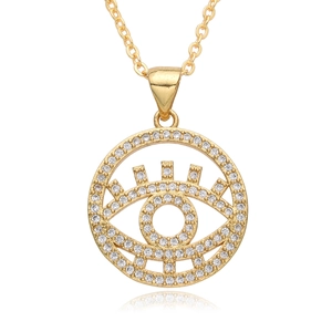 Macro detail of golden Evil Eye pendant with white zircon pavé and mirror reflection