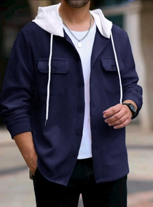 Detail of dark blue hooded jacket with waffle texture, button placket and front pockets