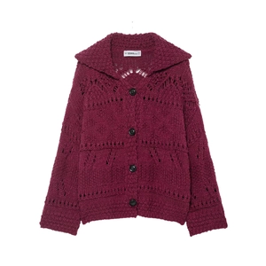 Detail of hollow knit texture and black buttons on a burgundy polo collar cardigan