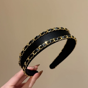 Minimalist black fabric headband with gold chain and leather woven detail for high skull top