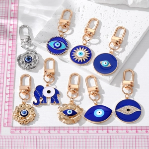 Bohemian evil eye keychains featuring elephant and floral charms with blue enamel finish