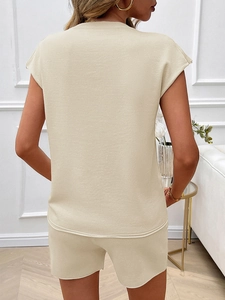 Rear view of beige knitted two-piece set featuring sleeveless top and casual shorts