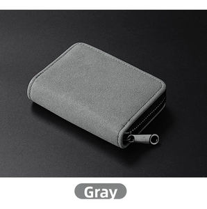 Detailed view of gray suede card holder with neat stitching and smooth zipper closure