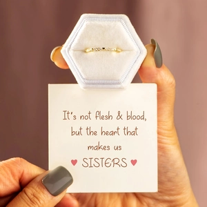Detail of a gold heart diamond ring presented in a velvet jewelry box with a gift card