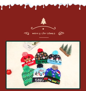 Flat lay of six colorful Christmas LED knit beanies featuring Santa and reindeer designs