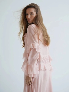 Detail of light pink ruffled sleeve and back design on long summer chiffon dress