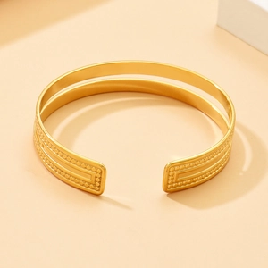 Minimalist double-layer gold open bangle with vintage beaded texture and polished finish