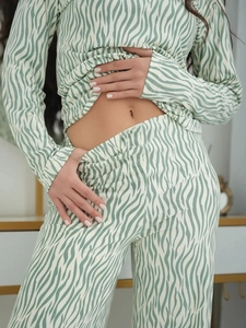 Detailed close-up of green zebra striped loungewear set showing the soft fabric texture