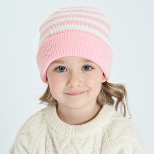 Detail of pink and white striped knitted beanie on child, soft winter ribbed texture
