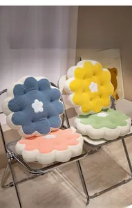 Close-up of thick waffle textured flower cushions in pastel pink, yellow, green and blue