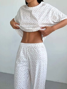 Detail showing elastic waistband of floral printed pajama set with red heart patterns