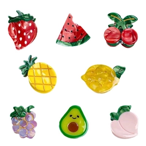 Mini fruit-shaped hair claws featuring vibrant strawberry watermelon and lemon designs