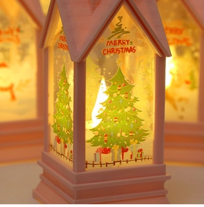 Detail of pink Christmas lantern with LED candle light and Merry Christmas tree patterns