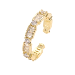 Detail of adjustable gold ring with alternating rectangular and round zircon stones