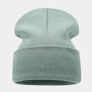 Detailed knit texture of the mint green beanie with a wide cuff for winter warmth