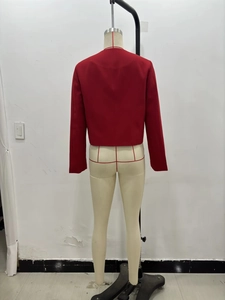 Detail view of the red short jacket back featuring textured 3D patterns and a gold button