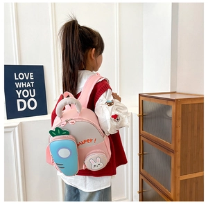 Detailed view of pink toddler backpack with carrot side pocket and cute rabbit coin pouch
