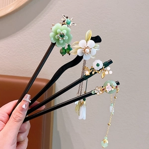 Set of four elegant sandalwood hair sticks with floral resin accents and long tassels
