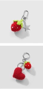 Detail of handmade crochet strawberry and heart keychains with metal star charms