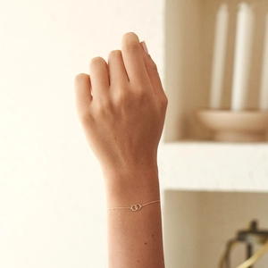 Detail of a minimalist gold S925 sterling silver interlocking double circle bracelet