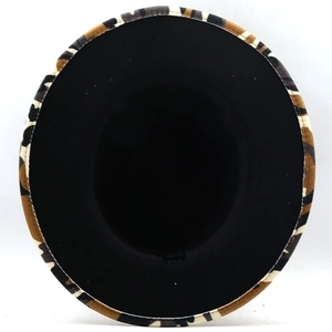 Detail view of the camouflage pattern brim and black fabric interior of the fedora hat