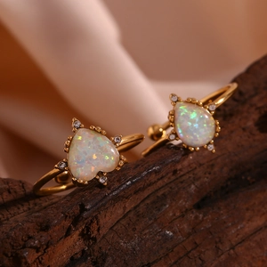 Detailed close-up of 18K gold plated rings featuring opal heart and teardrop stones