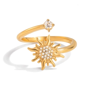 Detail of sun-shaped gold ring featuring a pavé center and a large accent diamond