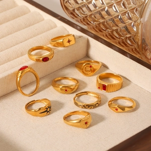 Set of 10 gold stainless steel star and moon rings displayed in a velvet jewelry box