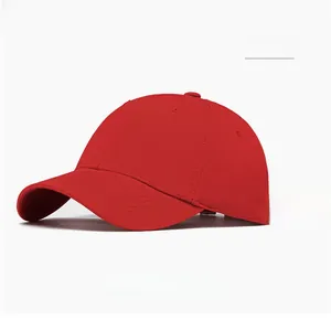 Detail of red baseball cap with long adjustable decorative strap and curved brim